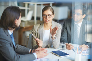 A Syntharis Group consultant explaining a growth strategy to a client